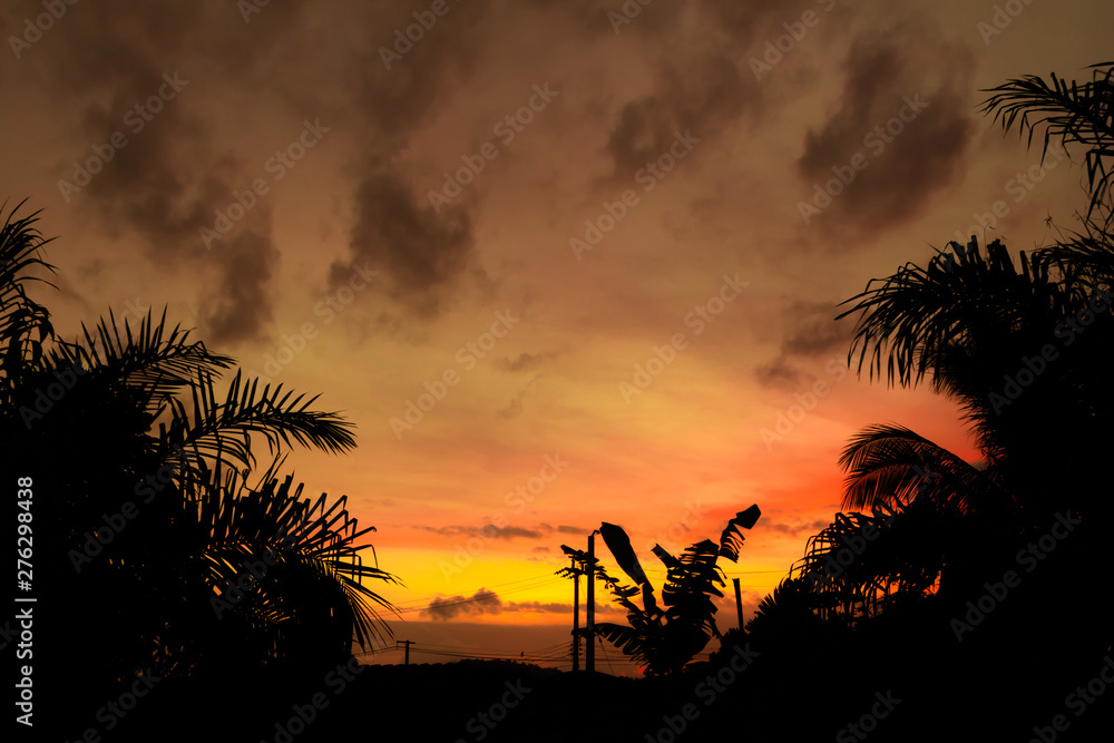 Yellow gold sky evening In tropical countries summer.Behind the village