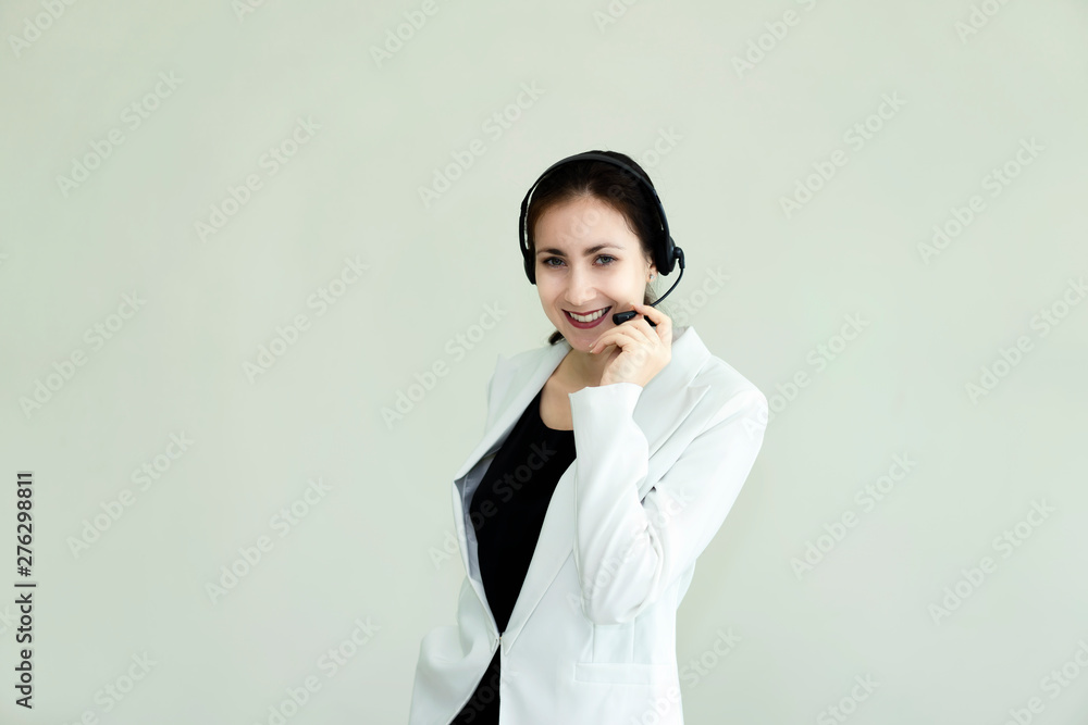 Woman dressed in suits, wearing headphones for receiving phone calls.Customer service by phone Woman dressed in suits, wearing headphones for receiving phone calls.Customer service by phone