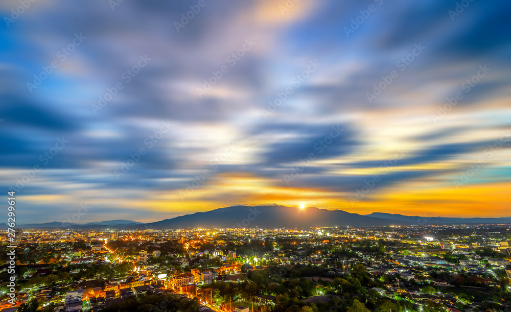 Chiang Mai cityscape at twilight from a high angle with light of building and Doi Suthep as a background.