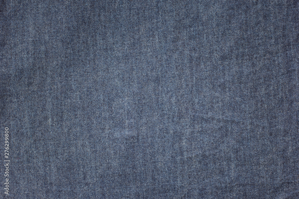 Old blue denim jeans texture or background with visible fibers Old blue denim jeans texture or background with visible fibers