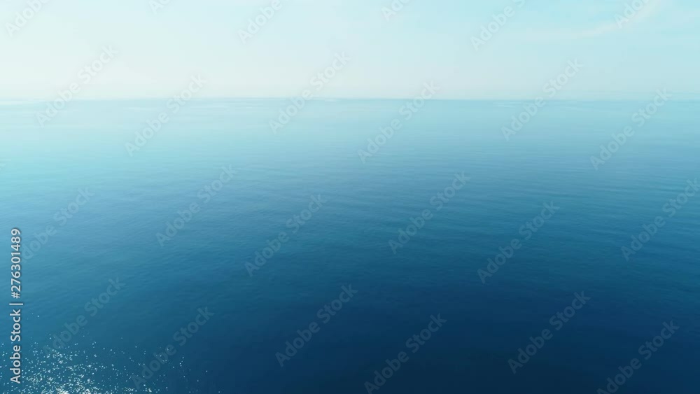 Flying over the turquoise water over the calm sea, aerial view. Sea background. Flying over the turquoise water over the calm sea, aerial view. Sea background.