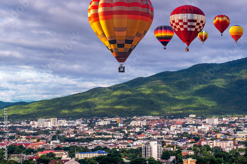 CHIANG MAI , THAILAND- JUNE 28, 2019 : Colorful hot-air balloons flying over Chiang Mai City with Doi Suthep Mountain background in Chiang Mai, Thailand.
