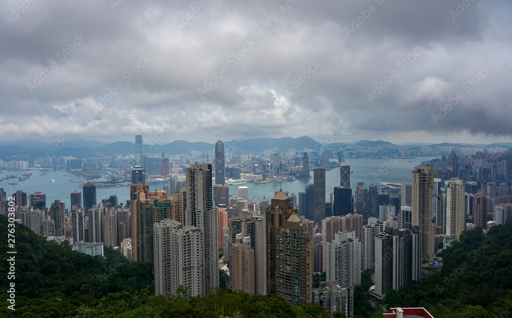 View of Honk Kong from the Victoria Peak, skyscrapers and overcast sky.  