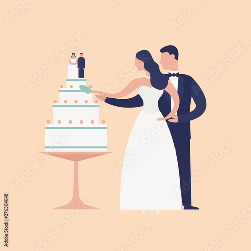 Adorable newlyweds cutting cake with topper isolated on light background