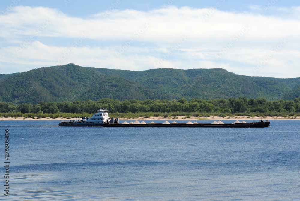 Fototapeta premium laden barge with rubble on the river