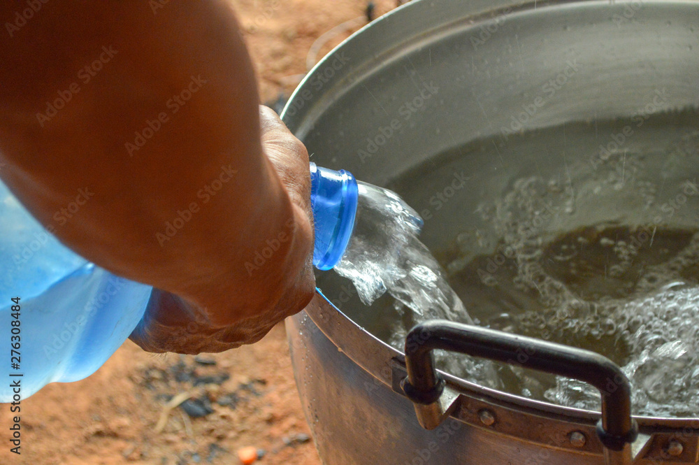 Pour water into the pot, boiling water, making soup.blurred photo Pour water into the pot, boiling water, making soup.blurred photo