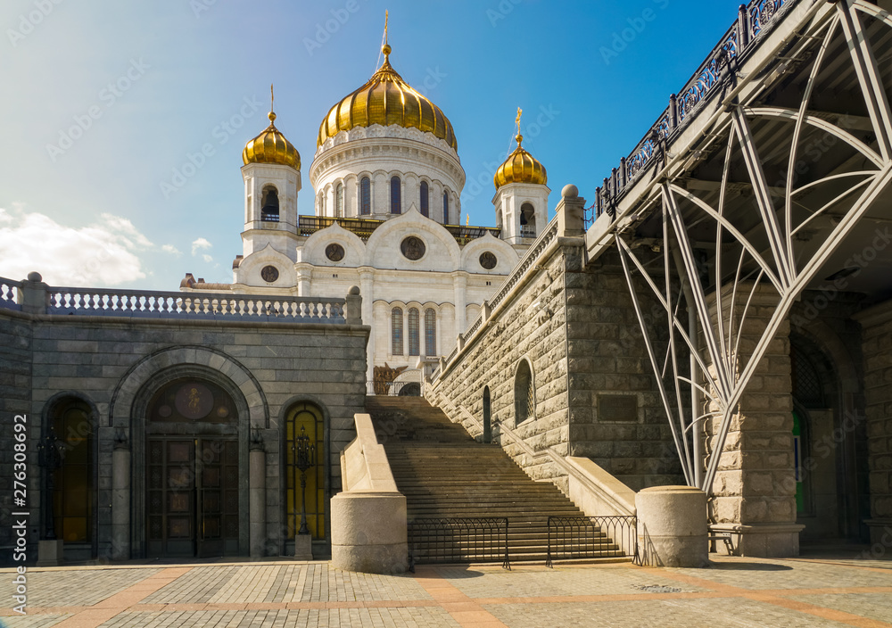 View of the Cathedral of Christ the Savior from the embankment of the Moskva River. In the foreground on the left is the entrance to the Hall of Church Cathedrals View of the Cathedral of Christ the Savior from the embankment of the Moskva River. In the foreground on the left is the entrance to the Hall of Church Cathedrals