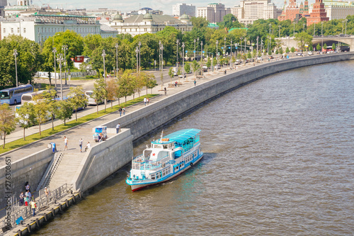 Photography River tram approaches the pier on the river in the city center