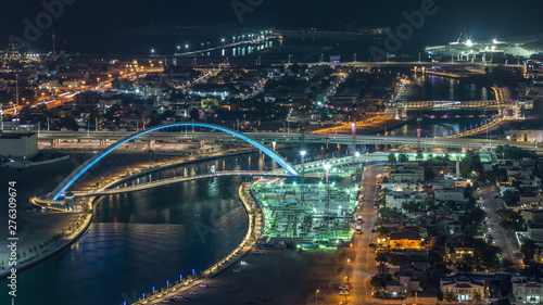 Dubai water canal with footbridge aerial night timelapse from Downtown skyscrapers rooftop © neiezhmakov
