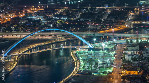 Dubai water canal with footbridge aerial night timelapse from Downtown skyscrapers rooftop © neiezhmakov