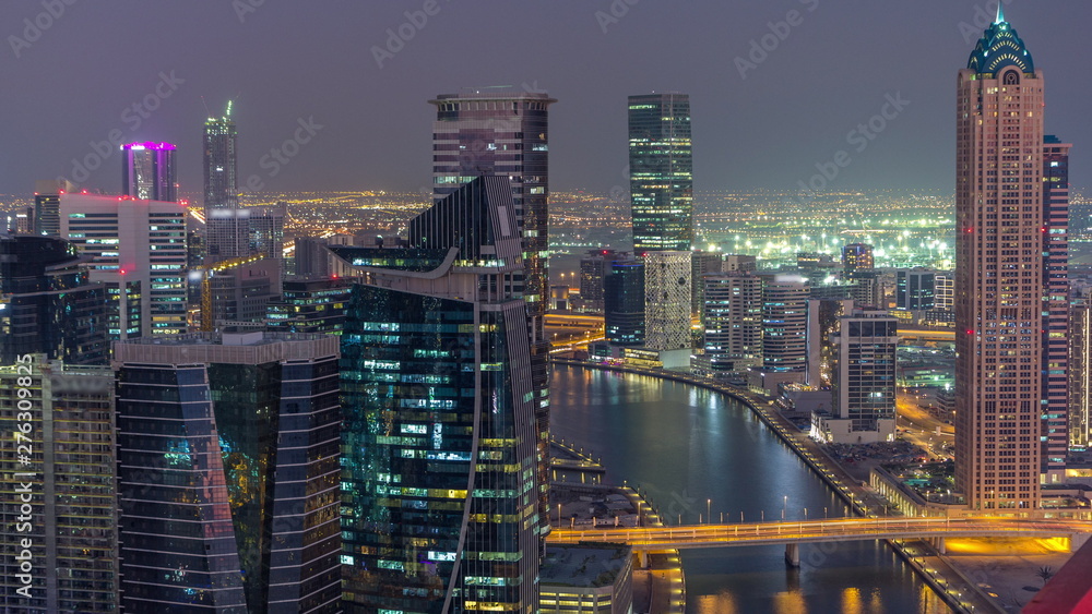 Aerial skyline of Dubai's business bay with skyscrapers day to night timelapse