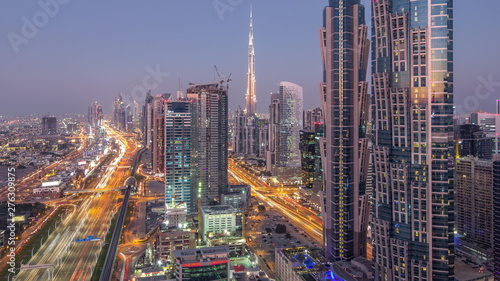 Evening skyline with modern skyscrapers and traffic on sheikh zayed road day to night timelapse in Dubai  UAE.