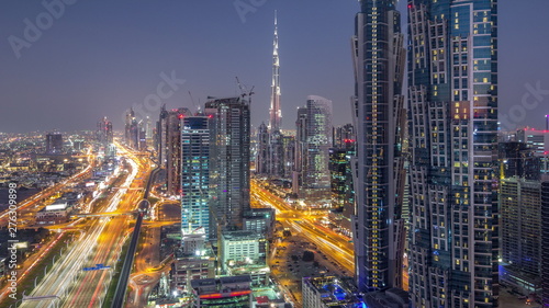 Evening skyline with modern skyscrapers and traffic on sheikh zayed road day to night timelapse in Dubai  UAE.
