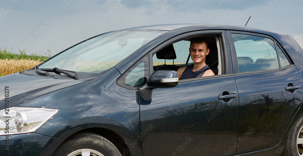Happy young man with new car - obrazy, fototapety, plakaty 