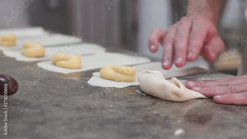 Pastry chef preparing xuixo, a traditional fried bun with cream in catalonia. photo