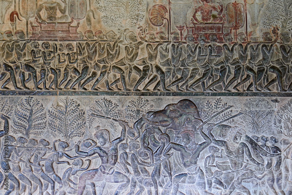 Famous bas reflief carved in the wall of Angkor Wat temple, world heritage and most visited tourist site, Cambodia. Details, close up of epic battles rock carving.