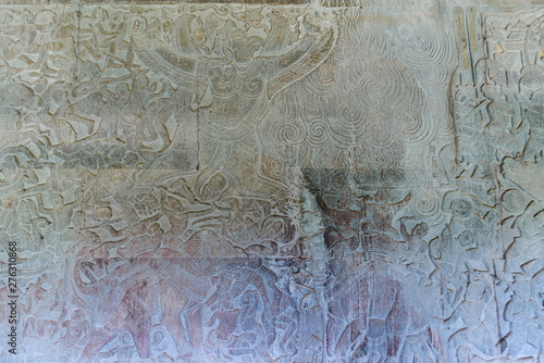 Famous bas reflief carved in the wall of Angkor Wat temple, world heritage and most visited tourist site, Cambodia. Details, close up of epic battles rock carving.