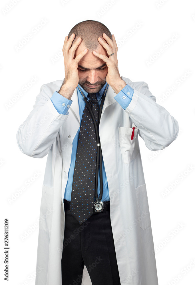 desperate doctor holds his head in his hands, wears a white coat. desperate doctor holds his head in his hands, wears a white coat.