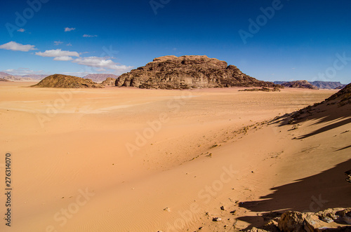 Desert with sandstone and granite rock in shape of boat in Wadi Rum in Jordan