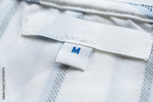 Blank white clothes label on new shirt