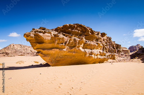 Desert with sandstone and granite rock in shape of boat in Wadi Rum in Jordan photo