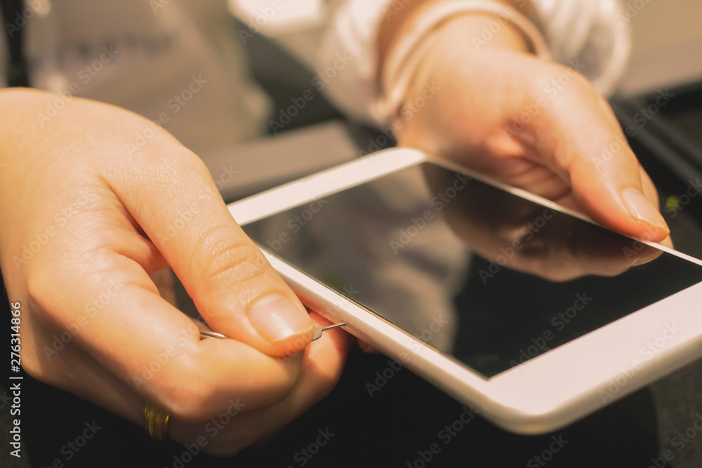 Employees are putting nano-SIM cards in the store for customers to buy women hands. Employees are putting nano-SIM cards in the store for customers to buy women hands.