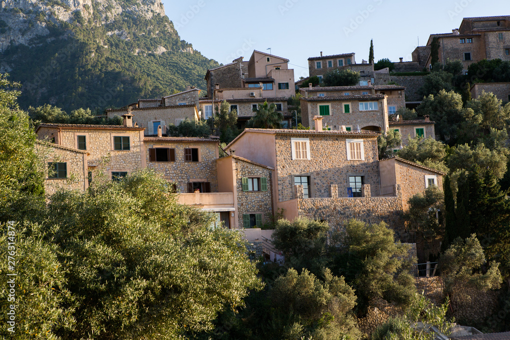 Beautiful view of old mountain village Deia in Mallorca on a sunny day. Deia traditional stone village in Majorca Tramuntana mountain