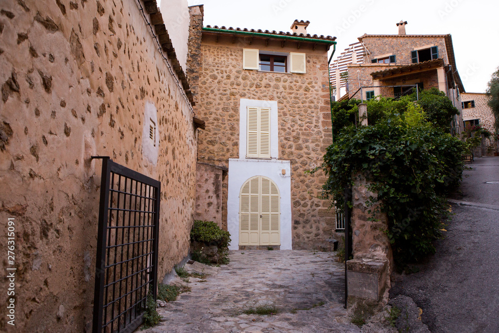 Beautiful view of old mountain village Deia in Mallorca on a sunny day. Deia traditional stone village in Majorca Tramuntana mountain Beautiful view of old mountain village Deia in Mallorca on a sunny day. Deia traditional stone village in Majorca Tramuntana mountain