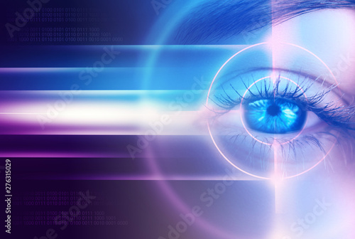 Eye of the female on a dark abstract background, neon holograms, retina scanner photo