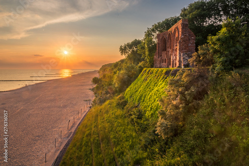 Fototapeta Naklejka Na Ścianę i Meble -  Sunrise over the ruins church in Trzesacz, Poland