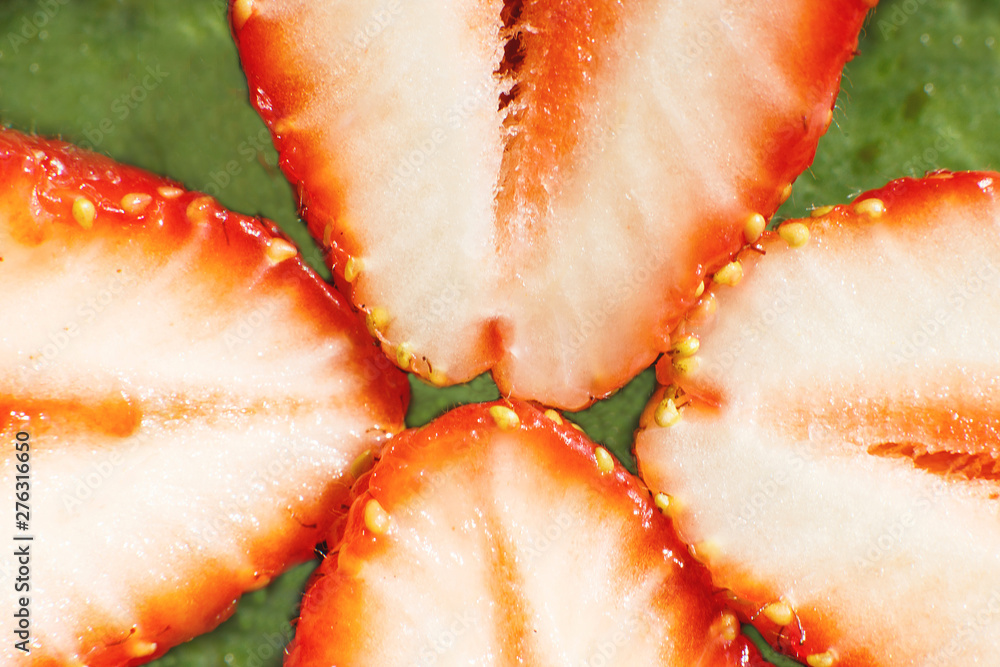 strawberry cut in half. strawberry core. half of a strawberry on a green background strawberry cut in half. strawberry core. half of a strawberry on a green background