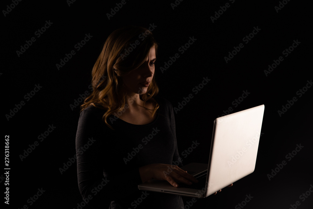 Depressed and worried woman with computer closed her mouth. Cyberbullying concept Depressed and worried woman with computer closed her mouth. Cyberbullying concept