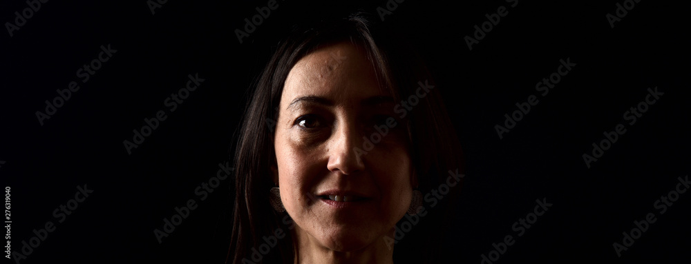 Fototapeta premium portrait of a woman on black