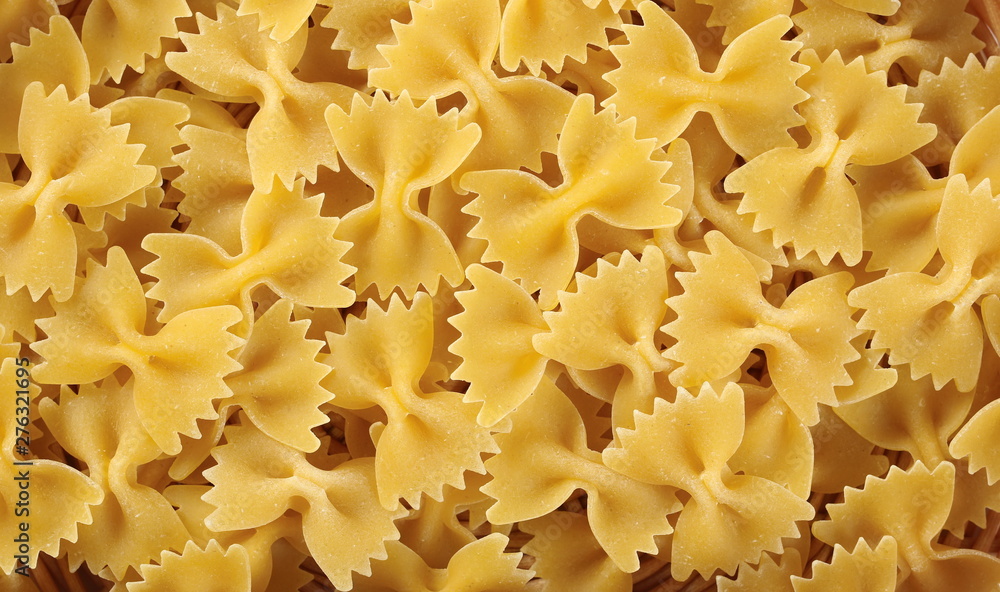 Farfalle pasta background and texture, top view Farfalle pasta background and texture, top view