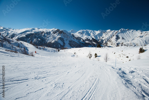 View down a piste in alpine ski resort © Paul Vinten