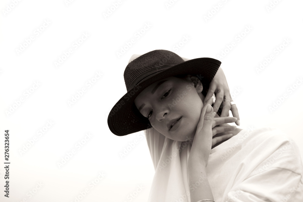 Fashion black and white portrait of a girl with a black hat. Beautiful young model. Contrast photo. Fashion black and white portrait of a girl with a black hat. Beautiful young model. Contrast photo.