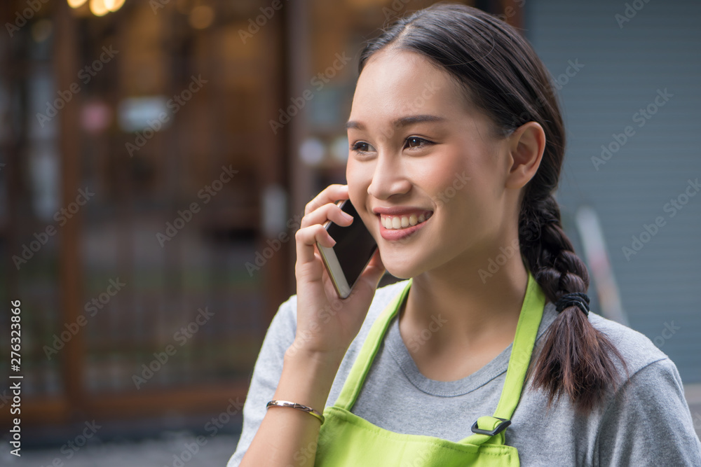 happy smiling small business owner, entrepreneur using smartphone happy smiling small business owner, entrepreneur using smartphone