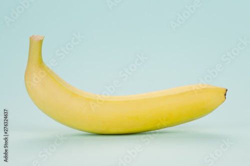 Banana on a soft blue background. Minimalism.