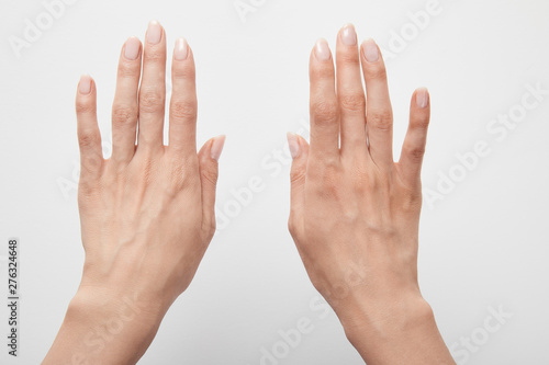 cropped view of woman hands isolated on white © LIGHTFIELD STUDIOS