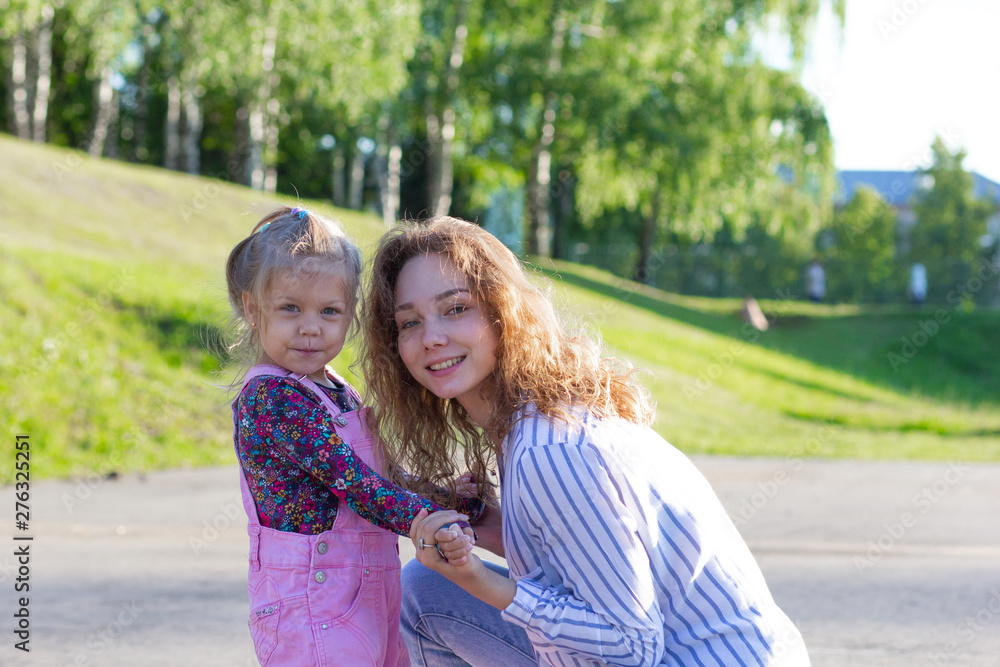 Young girl holding hands with smiling and beautiful child looking at camera