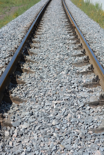 Repaired railroad tracks for freight trains with updated gray stone. © Daria Katiukha