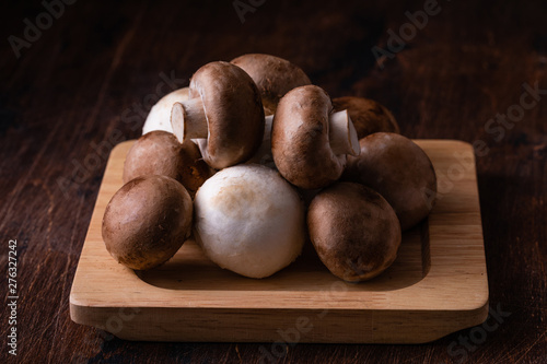 Close-up of fresh champignon mushrooms on wooden table