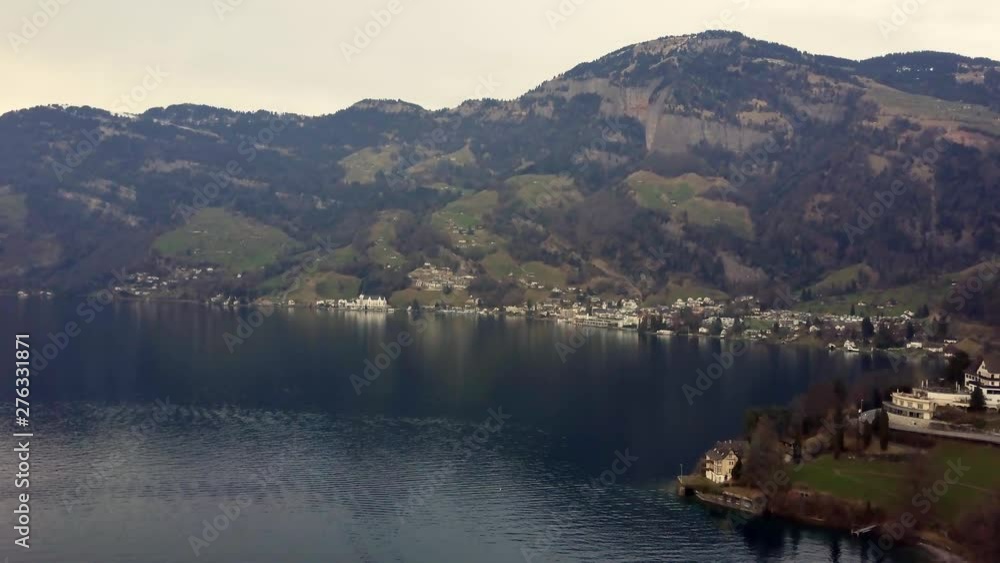 Aerial drone static shot of a lake covered with mist and fog surrounded by snow covered mountains and villages in Mont Blanc, France Aerial drone static shot of a lake covered with mist and fog surrounded by snow covered mountains and villages in Mont Blanc, France