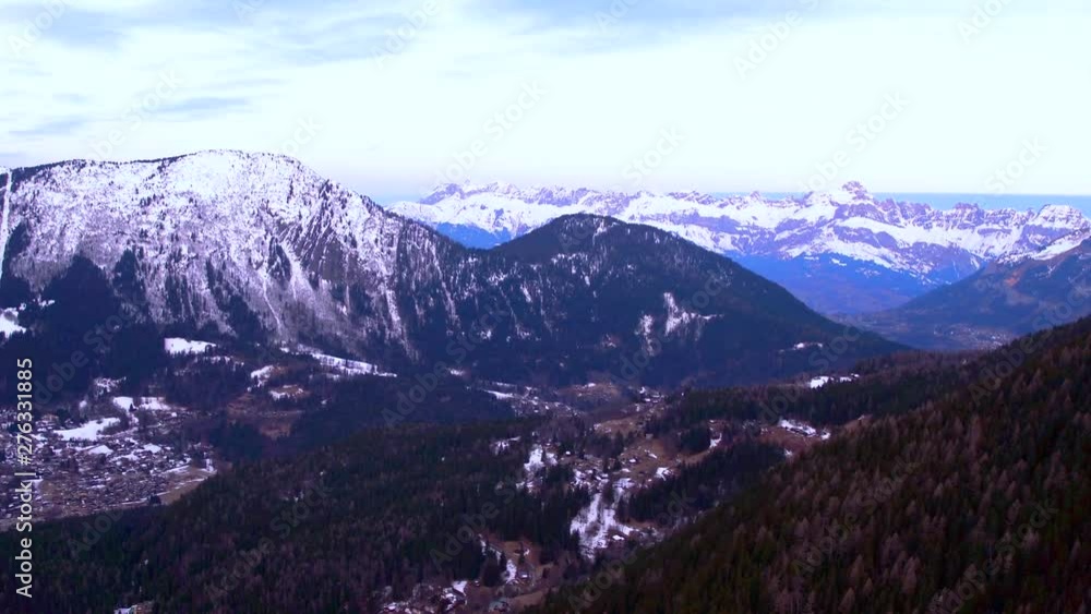 Aerial drone panning left shot of snow covered mountains covered in fog in Mont Blanc, France Aerial drone panning left shot of snow covered mountains covered in fog in Mont Blanc, France
