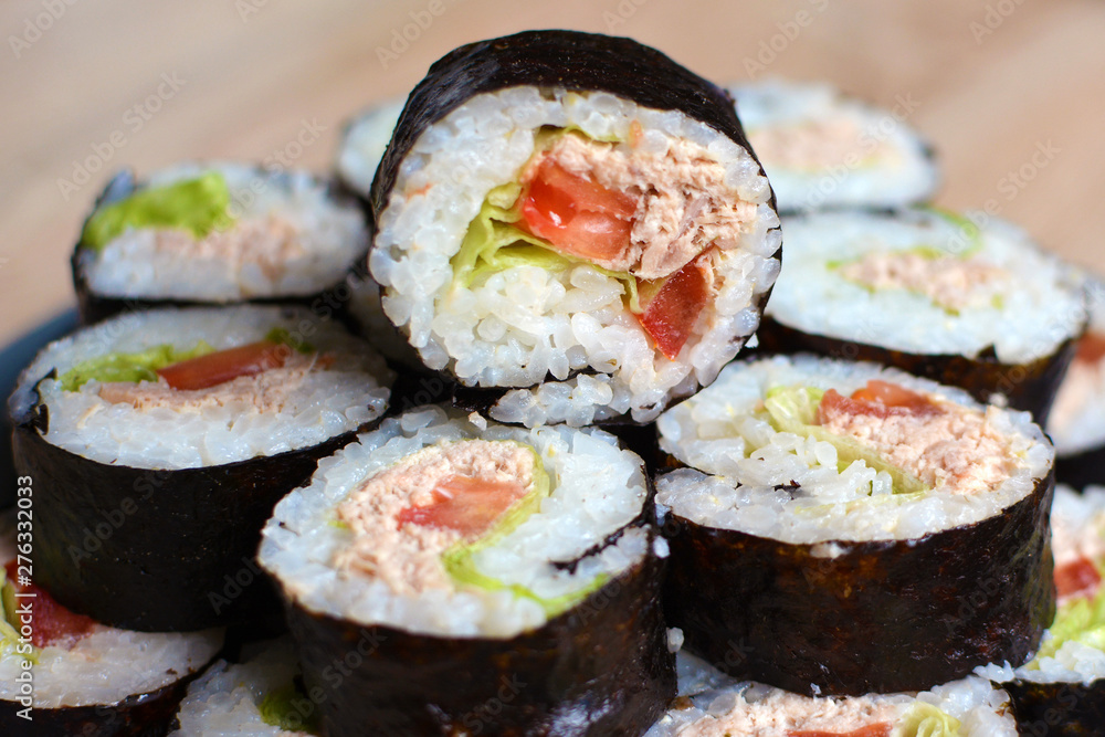 Stack of rolled Maki sushi with tuna, tomatoe and salad Stack of rolled Maki sushi with tuna, tomatoe and salad
