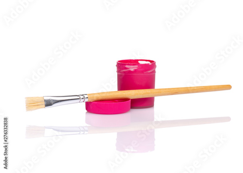 Opened red Gouache jar with wooden artist painting brush, isolated on white background with copy space. Cans of different colors gouache paints.