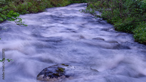 The rapids of the northern river in the night taiga