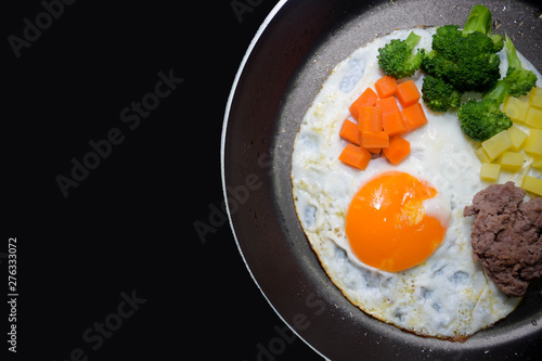 Breakfast pan egg, fried eggs with meat and vegetables