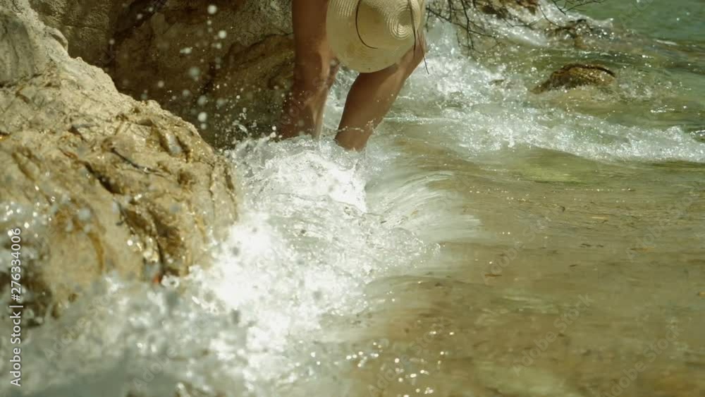 Attractive cheerful smiling blonde woman dressed in swimming suit and straw hat posing on beach, enjoying her travel, holiday and sea. Slow motion. HD Attractive cheerful smiling blonde woman dressed in swimming suit and straw hat posing on beach, enjoying her travel, holiday and sea. Slow motion. HD