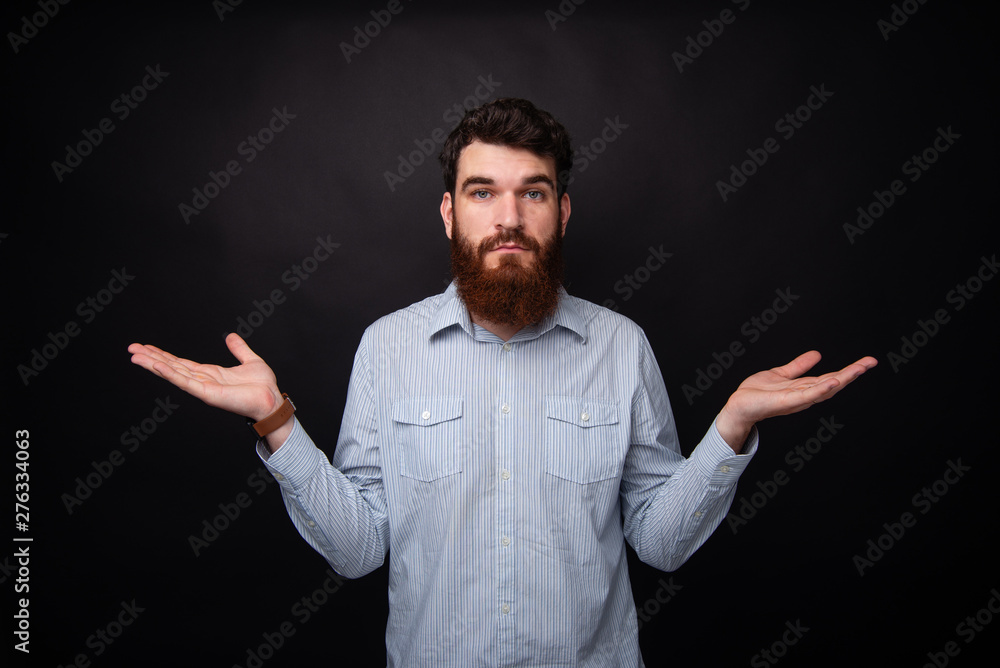 I don't know! Young bearded man gesturing with both hands he doesn't know. I don't know! Young bearded man gesturing with both hands he doesn't know.